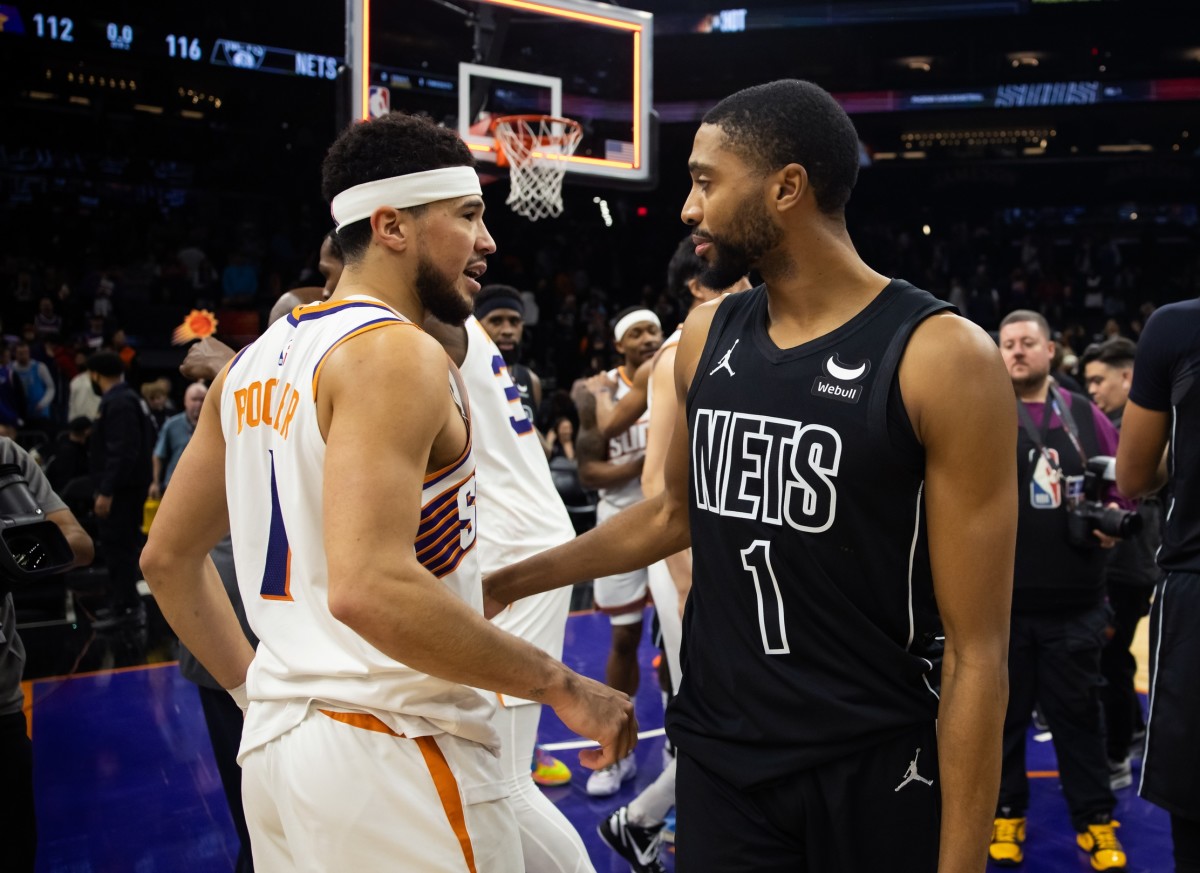 Phoenix Suns guard Devin Booker (left) greets Brooklyn Nets forward Mikal Bridges 