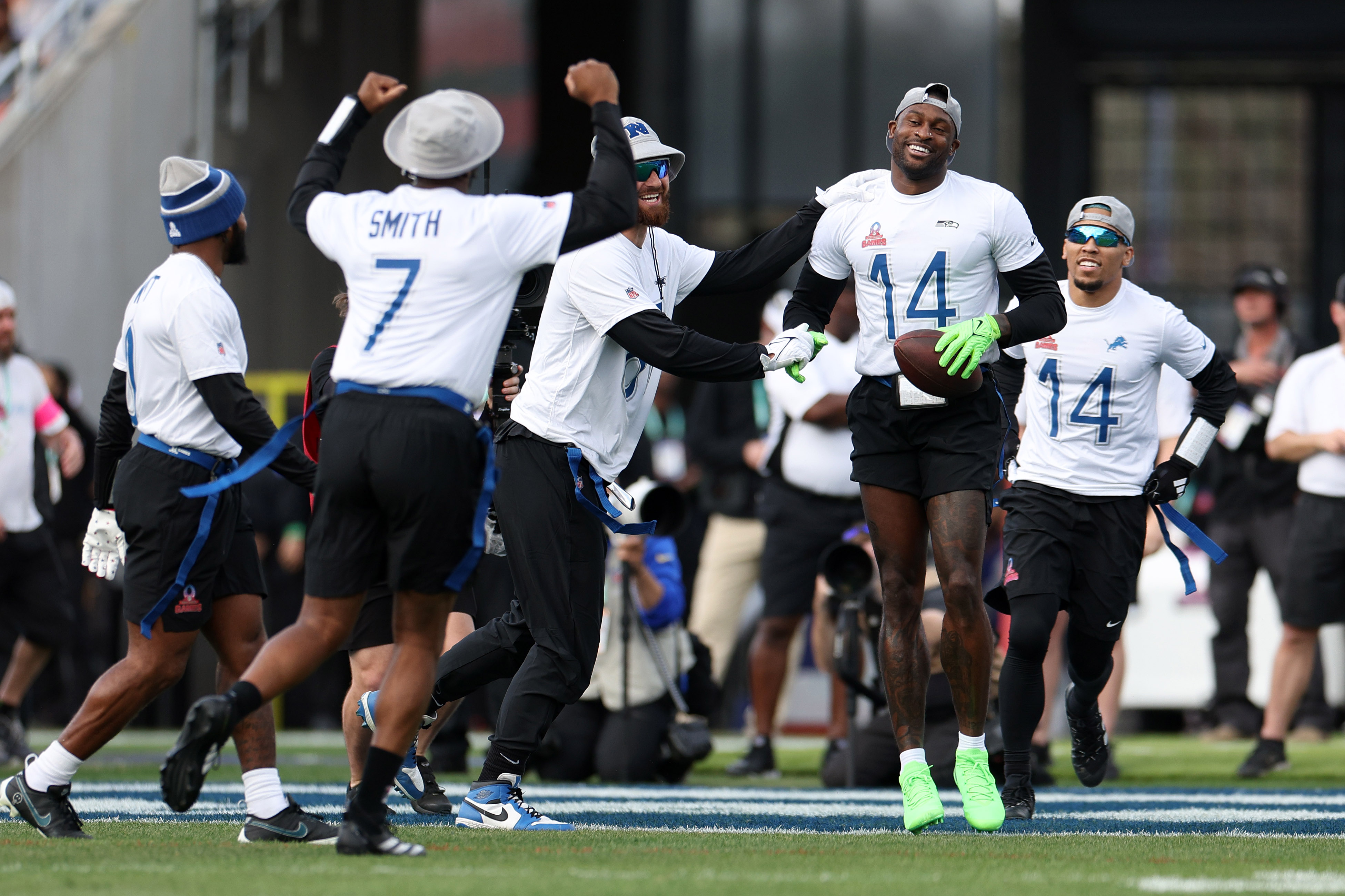 DK Metcalf holds the ball and jumps up and down in celebration