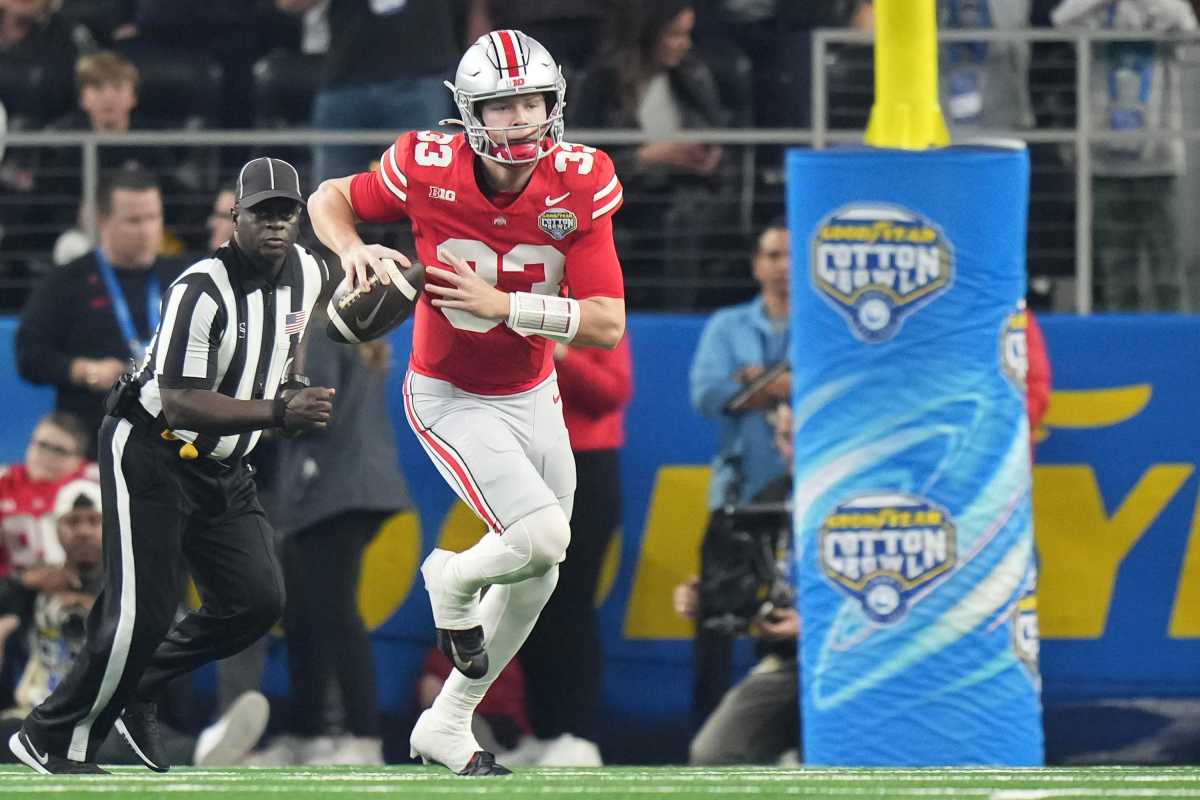 Dec 29, 2023; Arlington, Texas, USA; Ohio State Buckeyes quarterback Devin Brown (33) scrambles during the first quarter of the Goodyear Cotton Bowl Classic against the Missouri Tigers at AT&T Stadium.