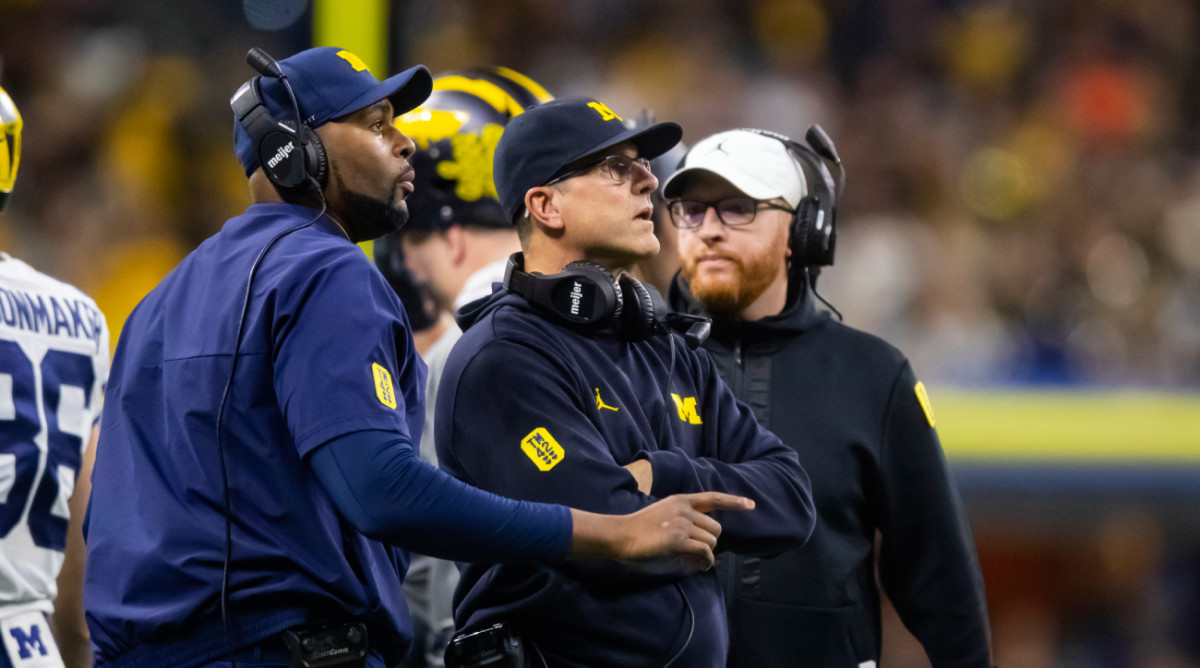 Michigan coaches Sherrone Moore, Jim Harbaugh and Jay Harbaugh during a game.