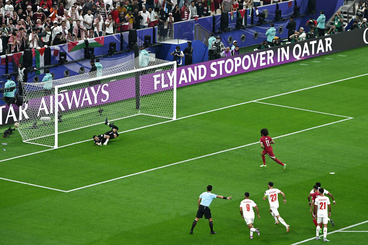 Akram Afif pictured (center) scoring one of his three penalty goals for Qatar during his team's 3-1 win over Jordan in the final of the 2023 AFC Asian Cup