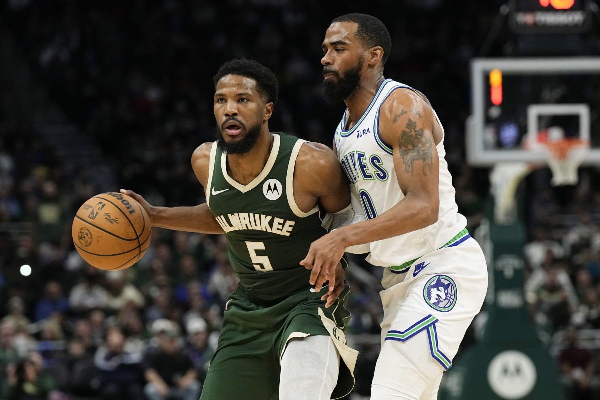  Milwaukee Bucks guard Malik Beasley (5) looks to pass the ball under pressure from Minnesota Timberwolves guard Mike Conley (10) 