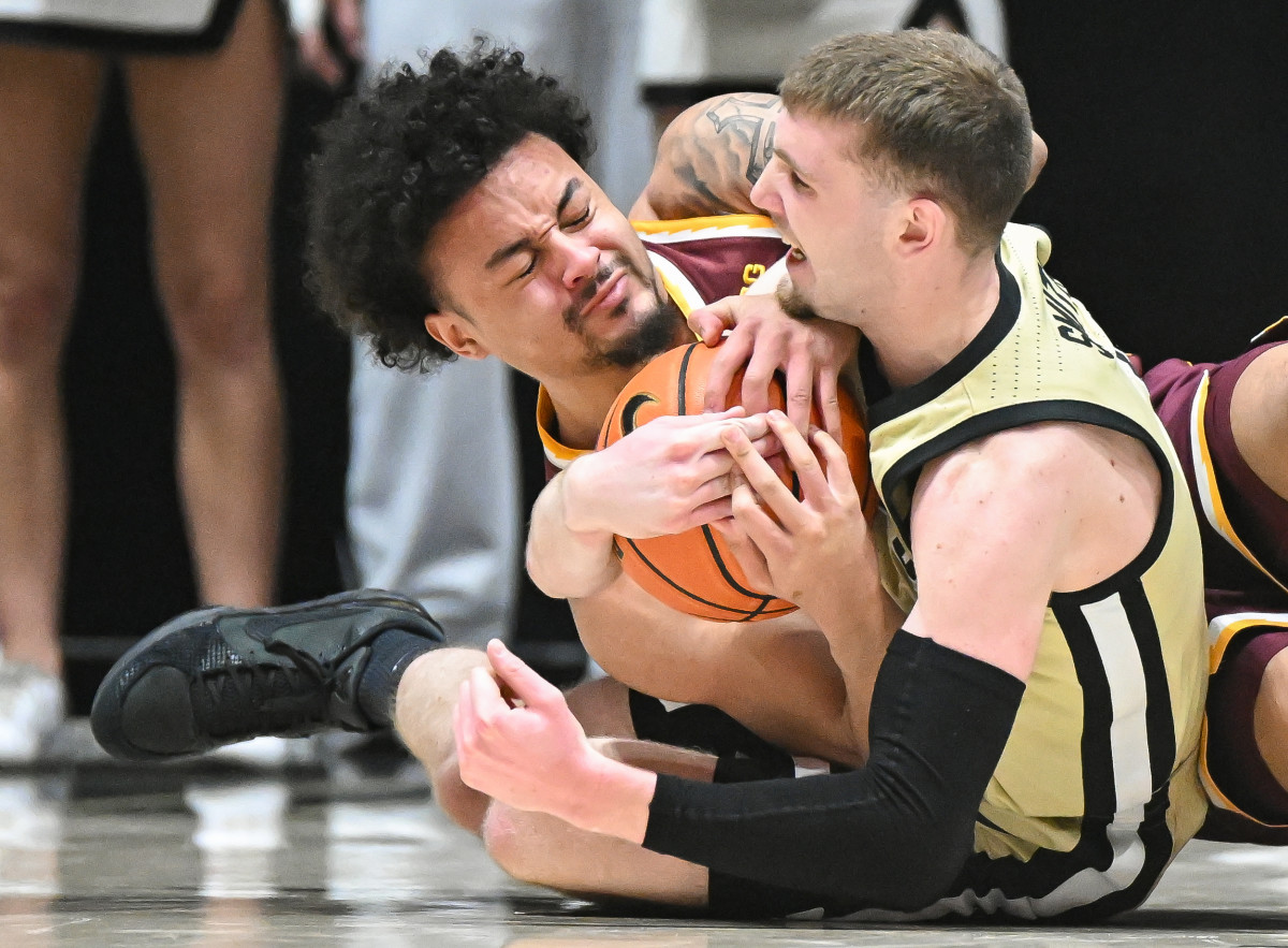 Minnesota guard Braeden Carrington (4) and Purdue guard Braden Smith (3) force a jump ball during the second half at Mackey Arena in West Lafayette, Ind., on Feb. 15, 2024.