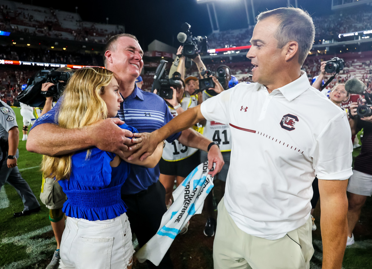 Shawn Elliott shares an embrace with his daughter after his postgame handshake with Shane Beamer (3rd Sept., 2022)