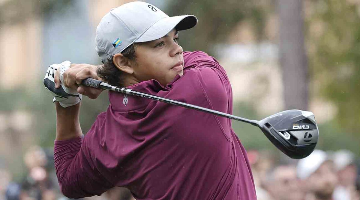 Charlie Woods plays his shot from the first tee during the 2023 PNC Championship at The Ritz-Carlton Golf Club in Orlando, Fla.