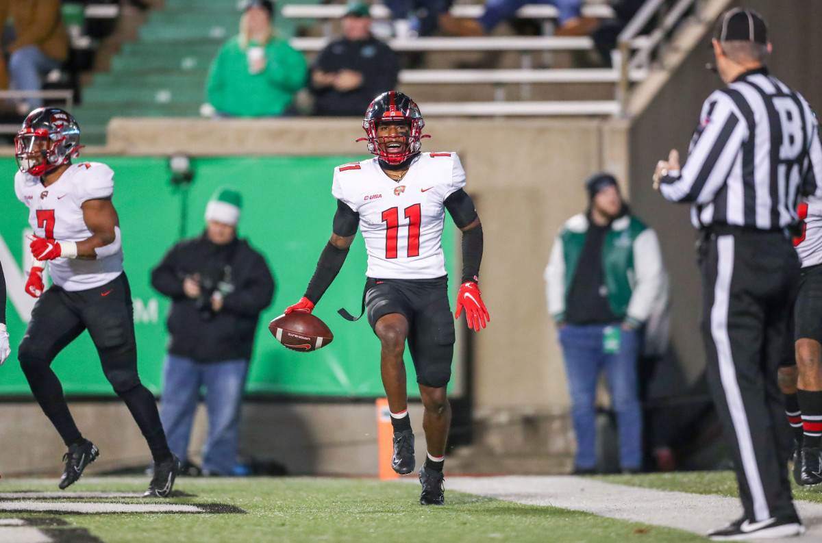 Nov 27, 2021; Huntington, West Virginia, USA; Western Kentucky Hilltoppers wide receiver Malachi Corley (11) catches a pass for a touchdown and celebrates with teammates during the third quarter against the Marshall Thundering Herd at Joan C. Edwards Stadium. Mandatory Credit: Ben Queen-USA TODAY Sports  