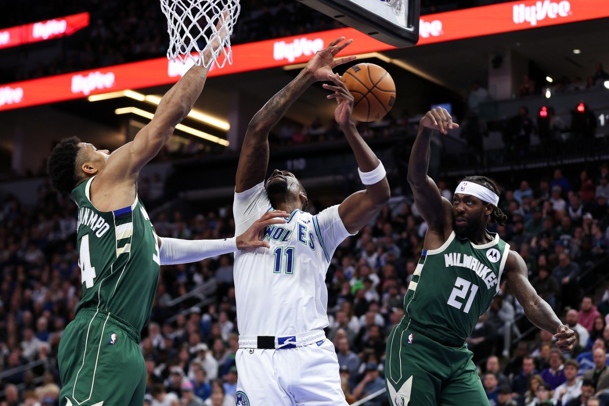 Feb 23, 2024; Minneapolis, Minnesota, USA; Milwaukee Bucks guard Patrick Beverley (21) blocks a shot by Minnesota Timberwolves center Naz Reid (11) during the second half at Target Center.