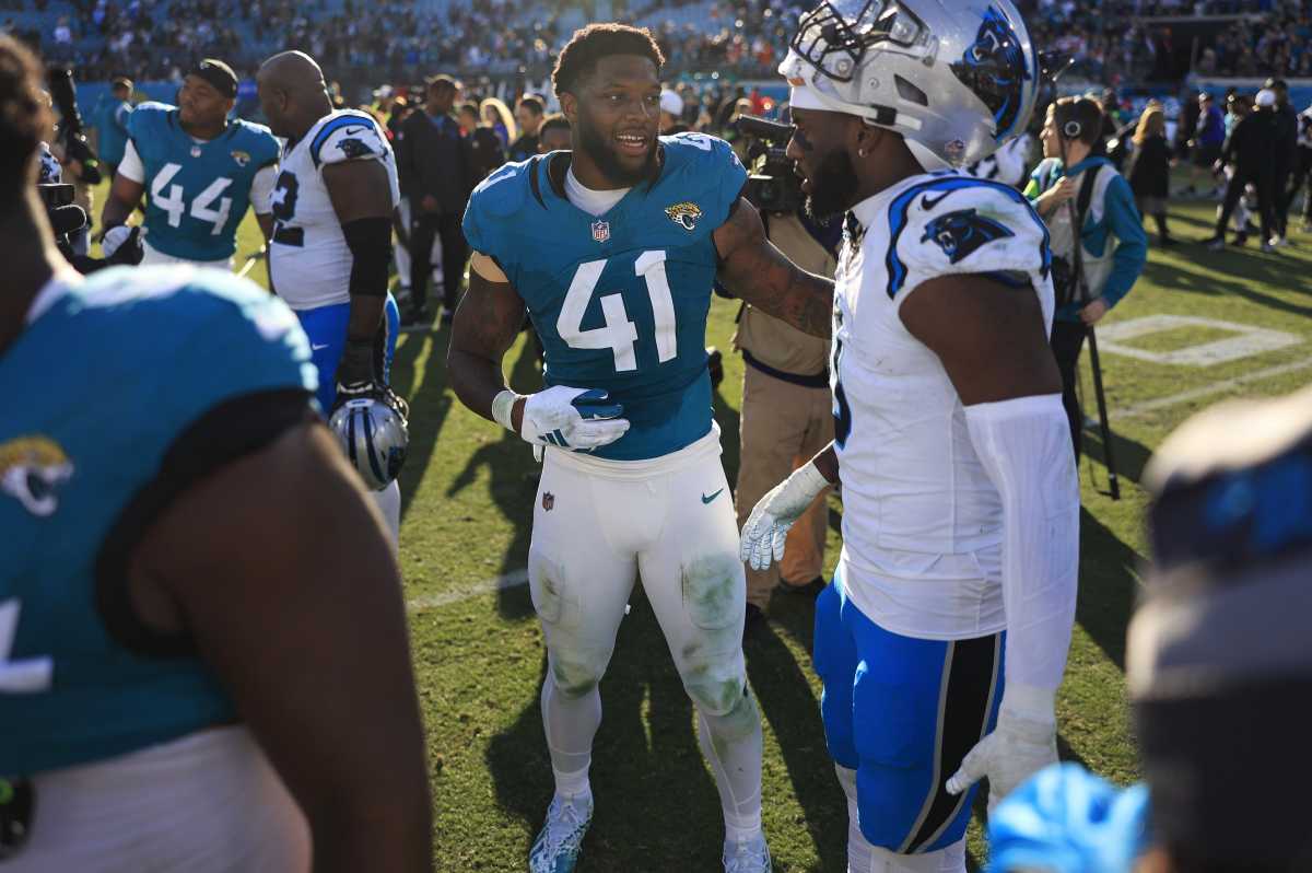 Josh Allen talks to Brian Burns on the field after the game