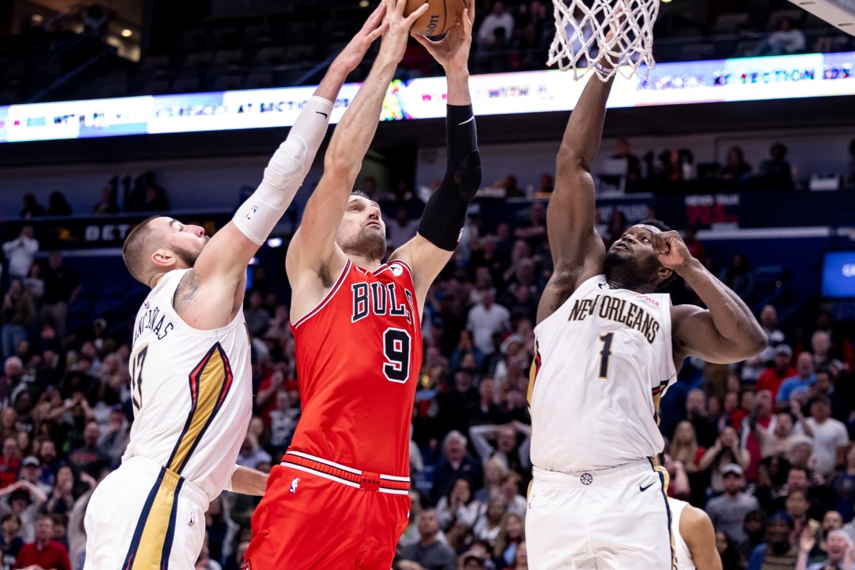 Chicago Bulls center Nikola Vucevic (9) drives to the basket against New Orleans Pelicans forward Zion Williamson (1) and center Jonas Valanciunas (17) during the second half at Smoothie King Center.