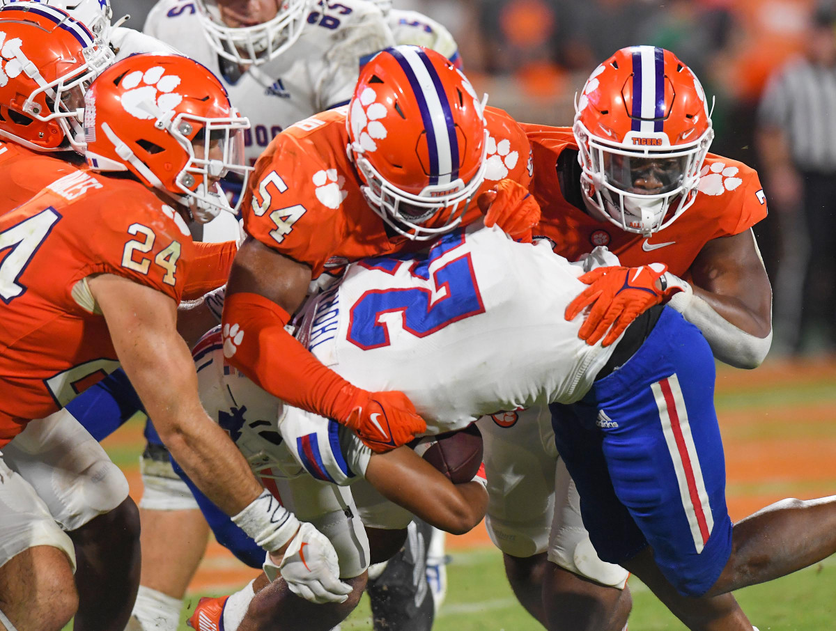 Sep 17, 2022; Clemson, South Carolina, USA; Clemson Tigers safety Tyler Venables (24) and linebacker Jeremiah Trotter Jr. (54) tackle Louisiana Tech Bulldogs running back Charvis Thornton (22) during the fourth quarter at Memorial Stadium.