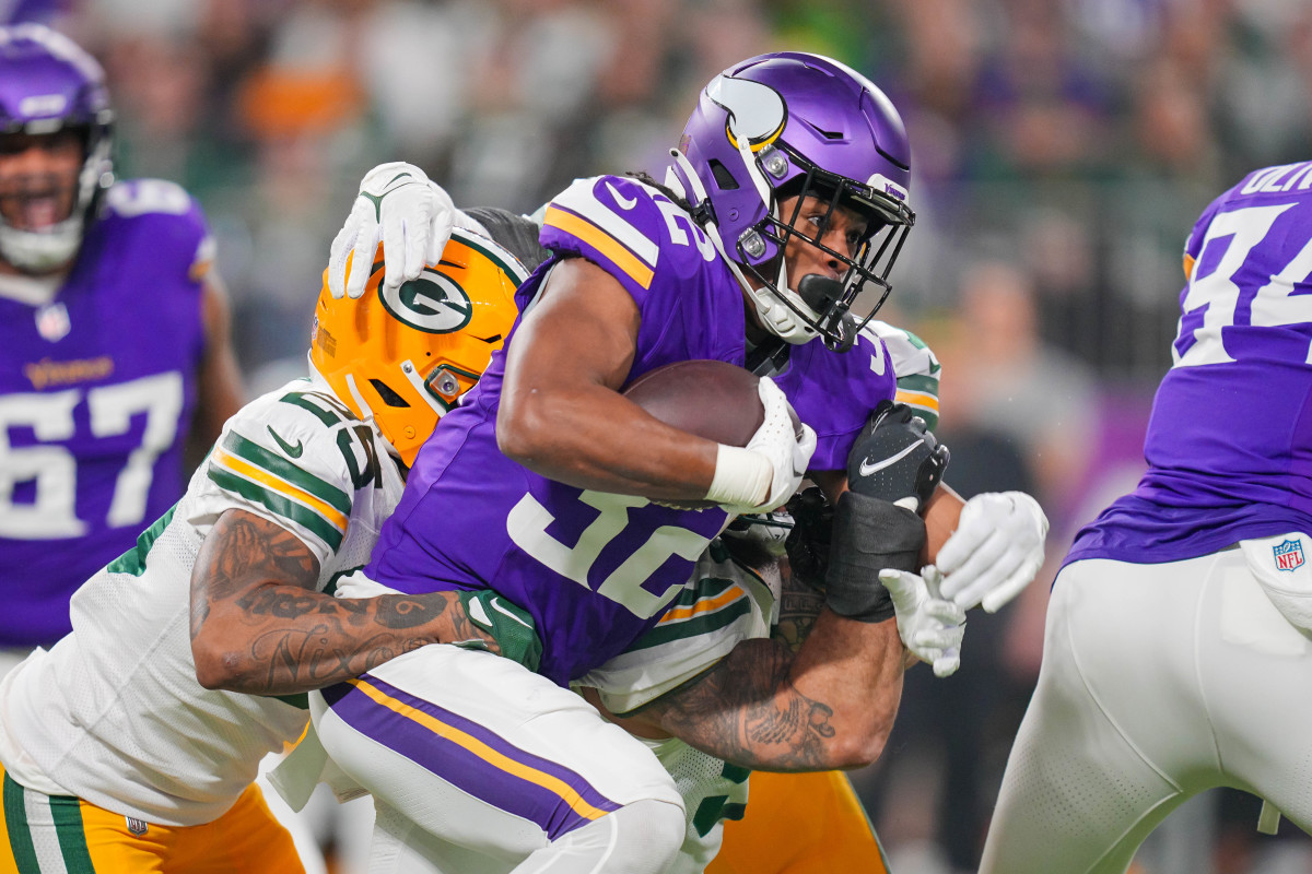 Dec 31, 2023; Minneapolis, Minnesota, USA; Minnesota Vikings running back Ty Chandler (32) runs with the ball against the Green Bay Packers in the first quarter at U.S. Bank Stadium.