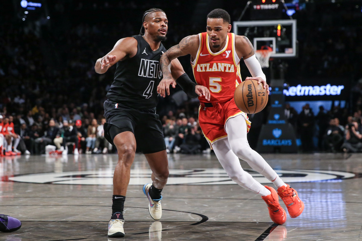 Feb 29, 2024; Brooklyn, New York, USA; Atlanta Hawks guard Dejounte Murray (5) moves past Brooklyn Nets guard Dennis Smith Jr. (4) in the fourth quarter at Barclays Center. Mandatory Credit: Wendell Cruz-USA TODAY Sports