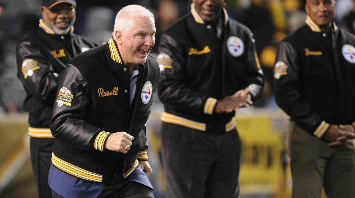 Former Steelers linebacker Andy Russell reacts to being announced at a Steelers game on the field.