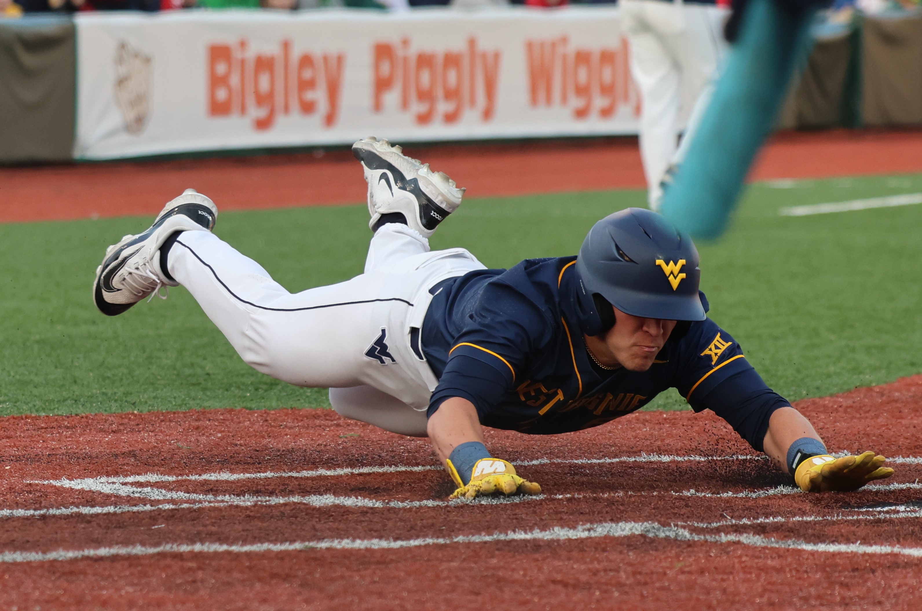 Freshman Spencer Barnett slides into home in the Mountaineers win against Marshall.