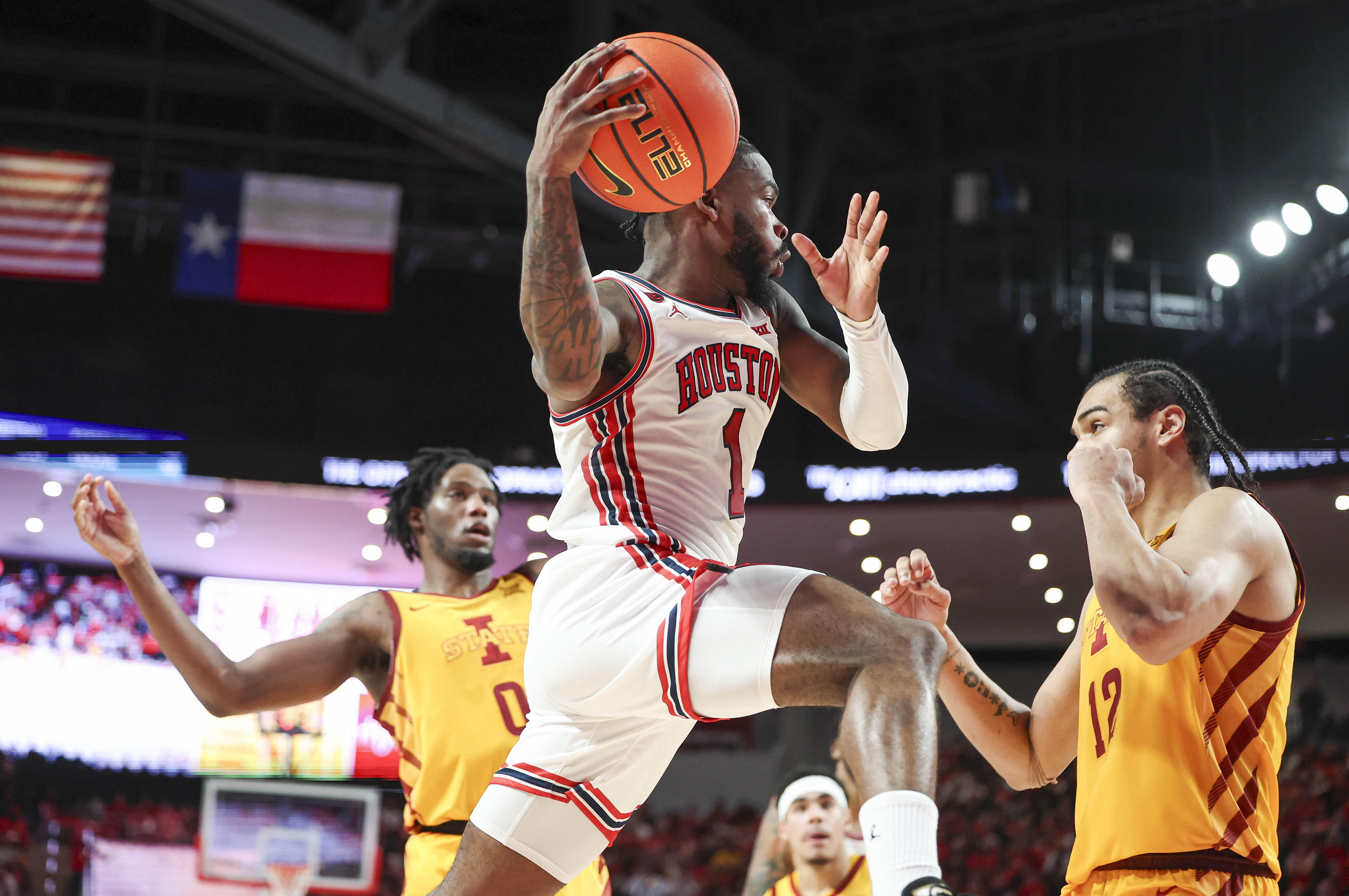 Houston guard Jamal Shead (1) looks to pass the ball during the second half against Iowa State at Fertitta Center in Houston on Feb. 19, 2024.