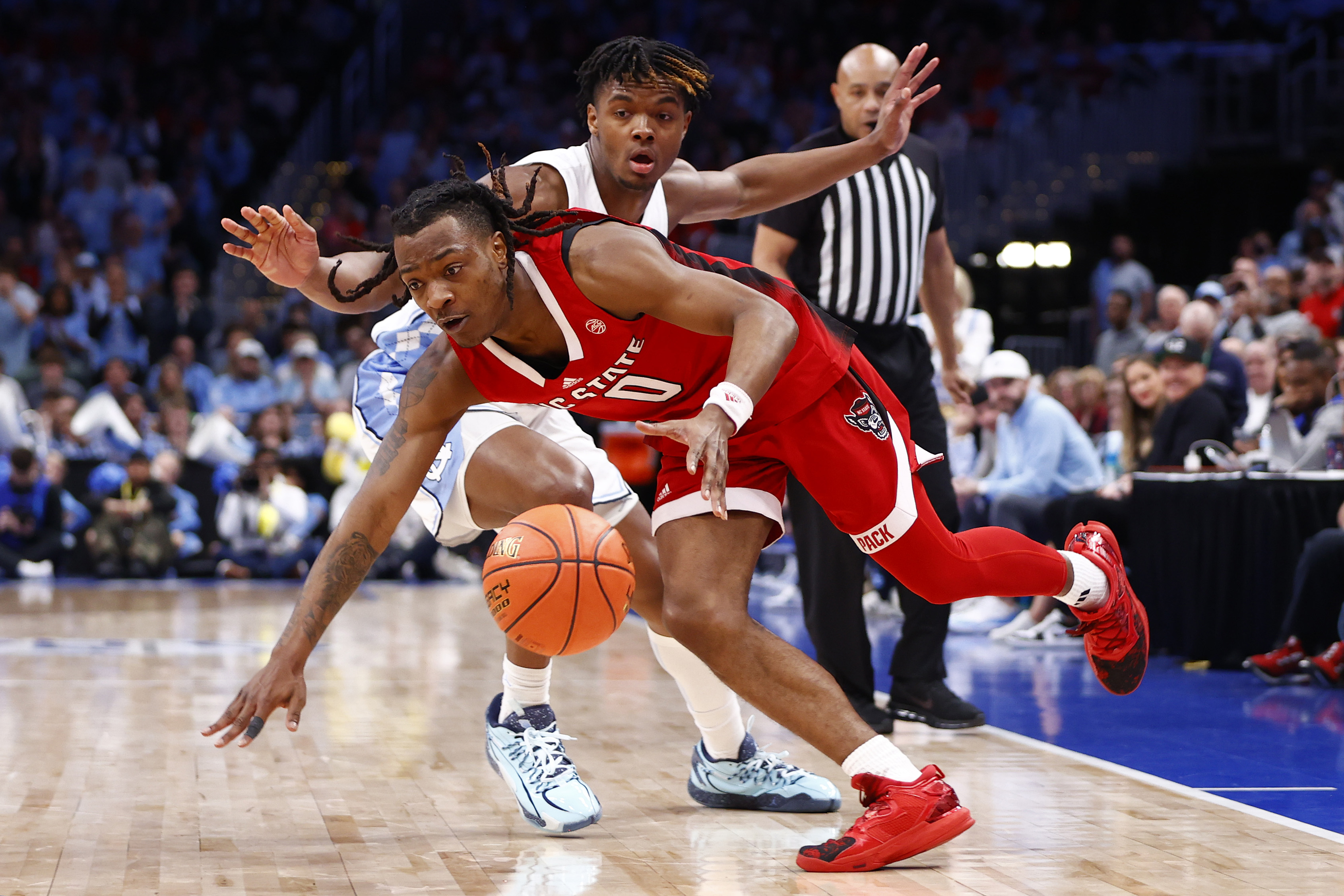 North Carolina State guard DJ Horne (0) dribbles past the North Carolina defense during the second half at Capital One Arena in Washington on March 16, 2024.