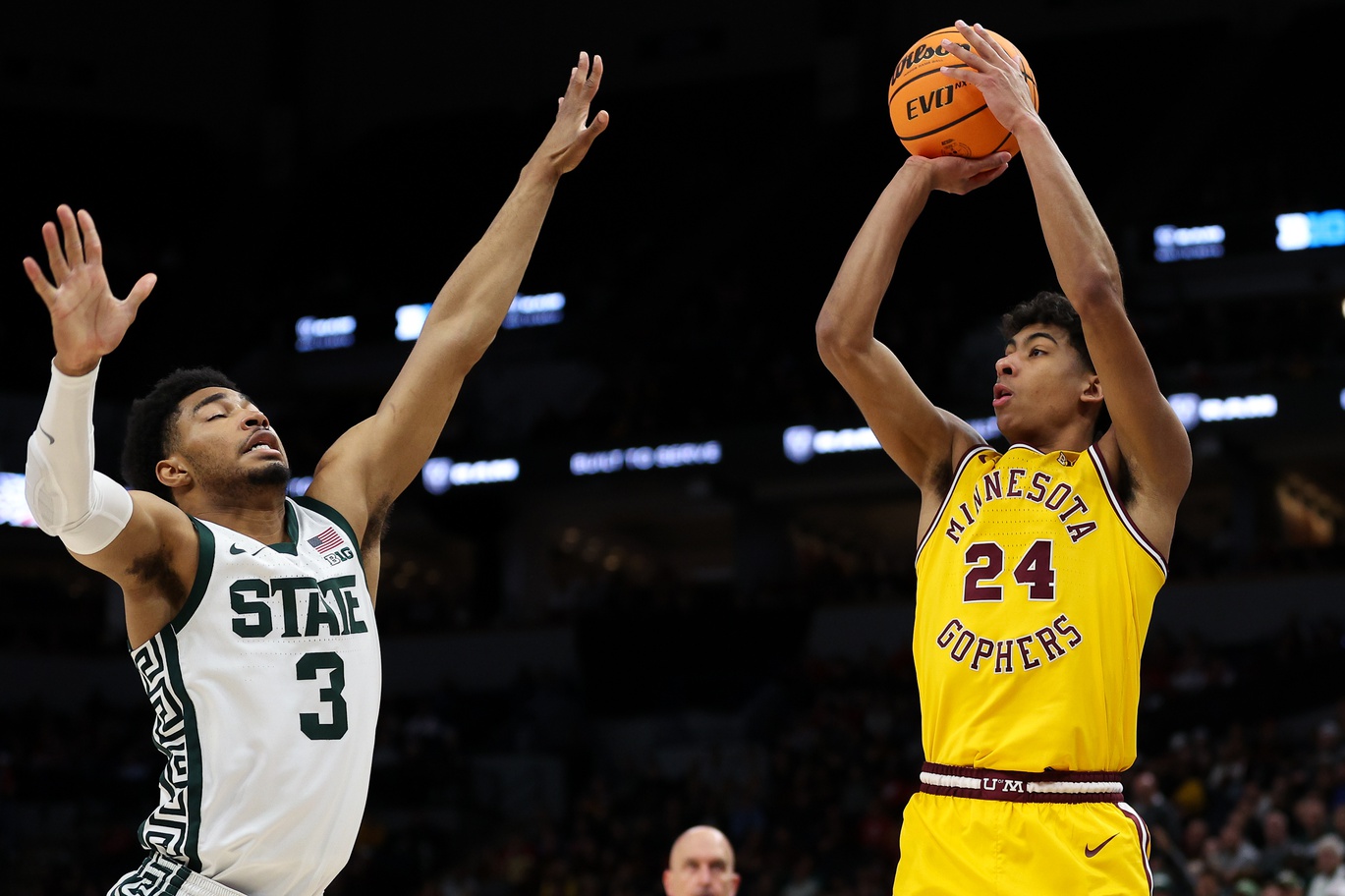 Mar 14, 2024; Minneapolis, MN, USA; Minnesota Golden Gophers guard Cam Christie (24) shoots as Michigan State Spartans guard Jaden Akins (3) defends during the second half at Target Center.