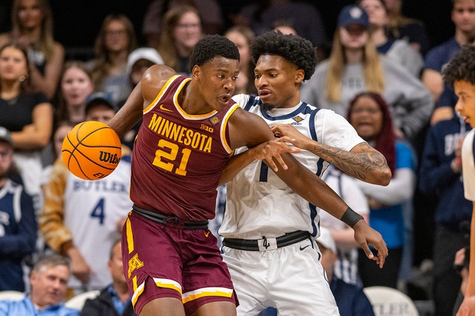 Butler Bulldogs forward Jalen Thomas (1) attempts to steal the ball away from Minnesota Golden Gophers forward Pharrel Payne (21) during the first half of an NCAA/NIT game, Tuesday, March 19, 2024, at Hinkle Fieldhouse on the campus of Butler University in Indianapolis.  