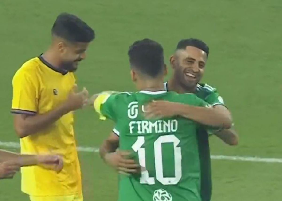 Roberto Firmino pictured hugging Riyad Mahrez after they combined for a goal on their Saudi Pro League debuts for Al-Ahli in August 2023