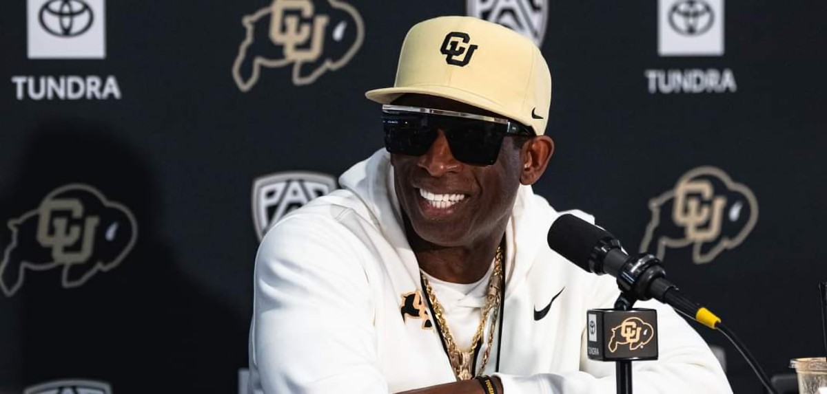 Deion Sanders at the podium during 2023 Media Day