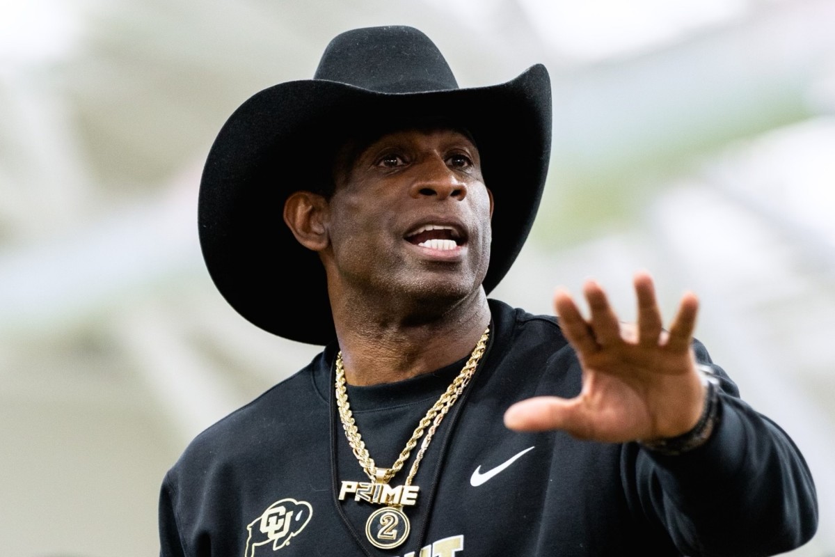 Deion Sanders talks to players in practice