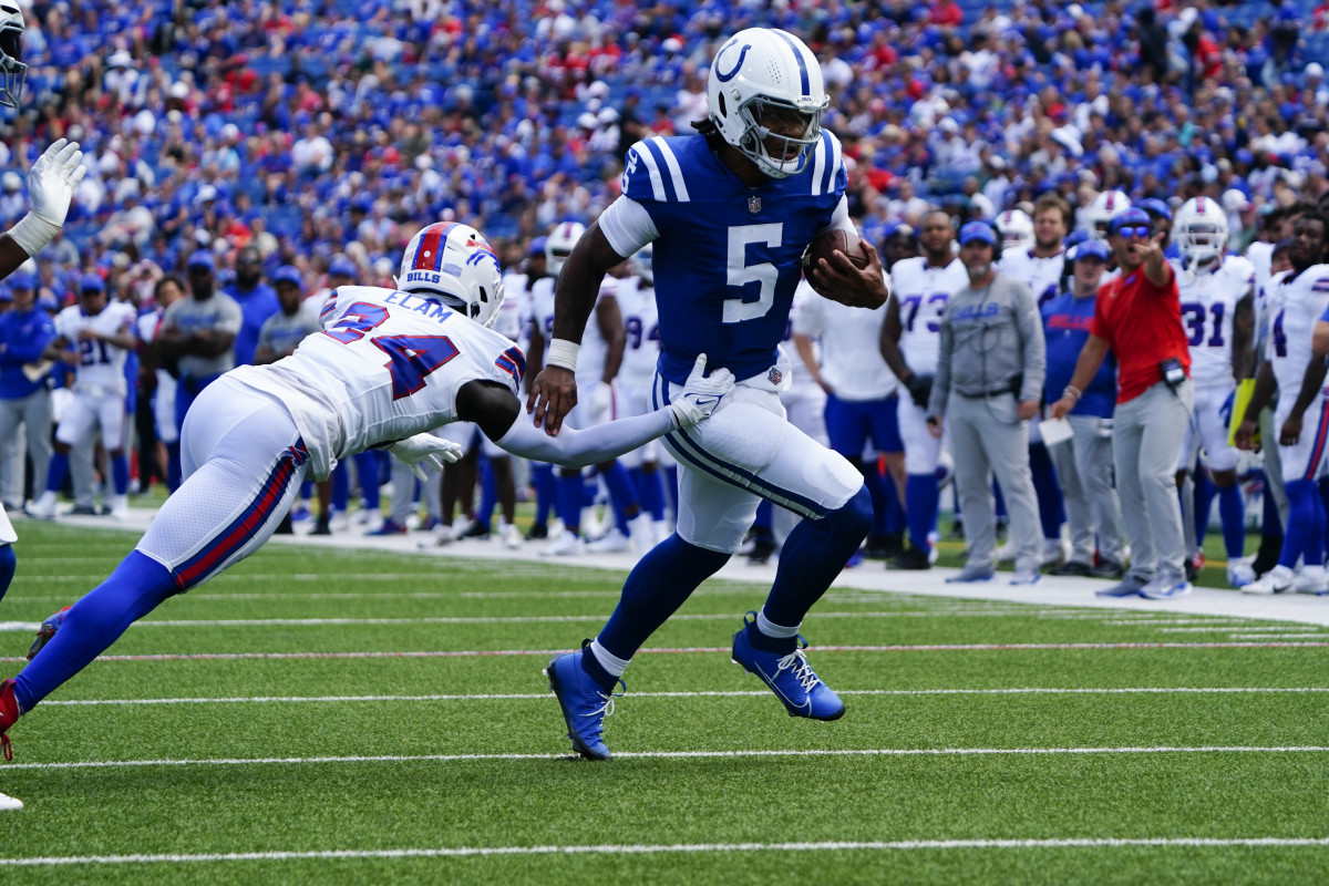 Aug 12, 2023; Orchard Park, New York, USA; Indianapolis Colts quarterback Anthony Richardson (5) breaks a tackle attempt by Buffalo Bills defensive back Kaiir Elam (34) during the first half at Highmark Stadium. Mandatory Credit: Gregory Fisher-USA TODAY Sports