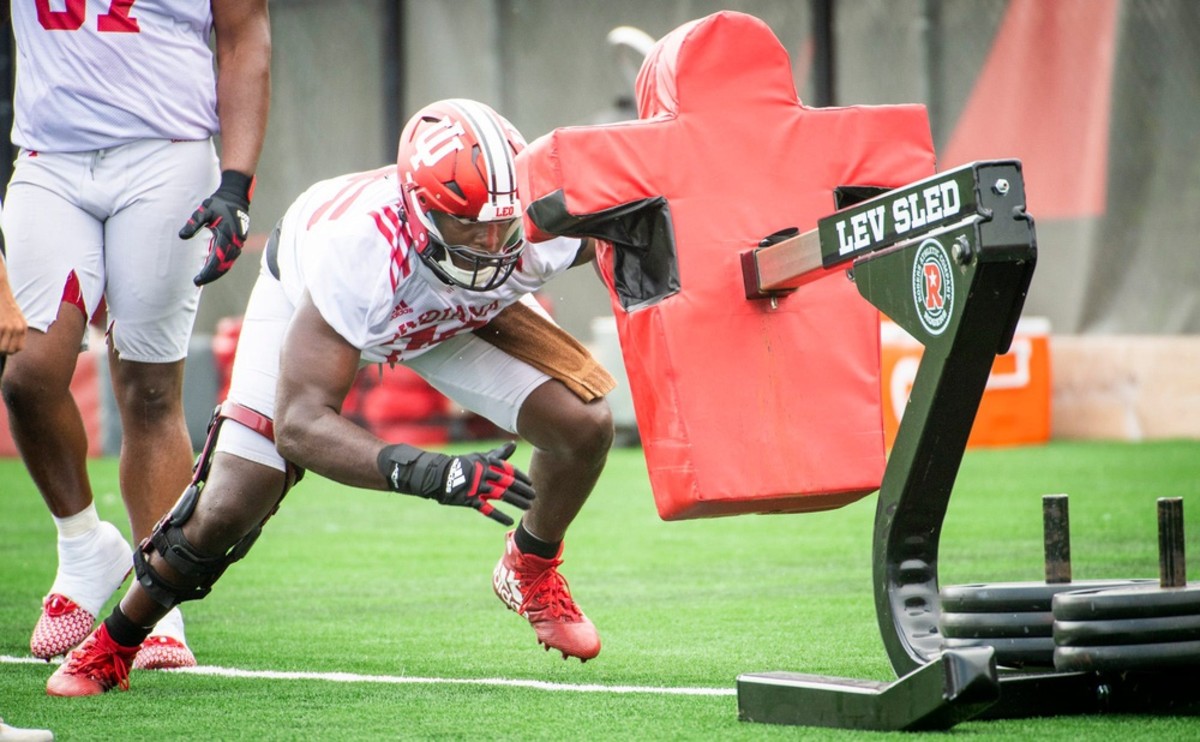 Indiana's Matthew Bedford (76) lunges toward the sled during the first day of fall camp for Indiana football at their practice facilities on Wednesday, Aug. 2, 2023.