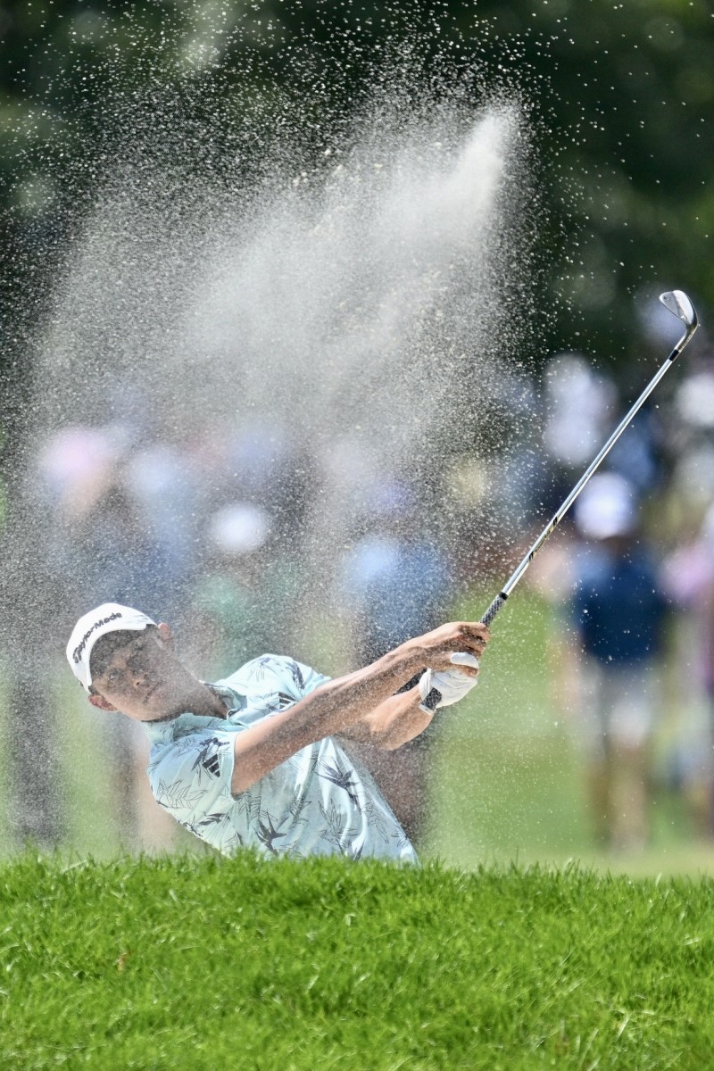 Collin Morikawa hits out of the sand