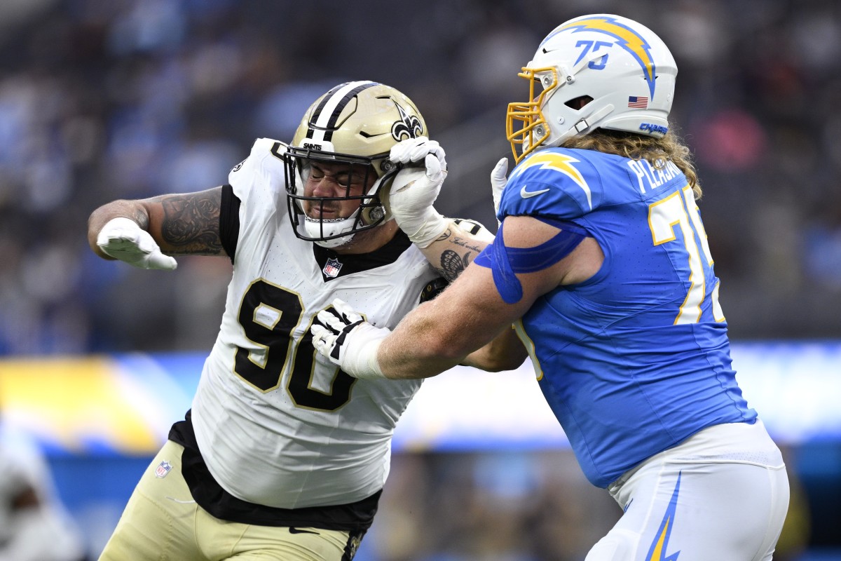 Los Angeles Chargers guard Austen Pleasants (75) attempts to block New Orleans Saints defensive tackle Bryan Bresee (90). Mandatory Credit: Orlando Ramirez-USA TODAY Sports