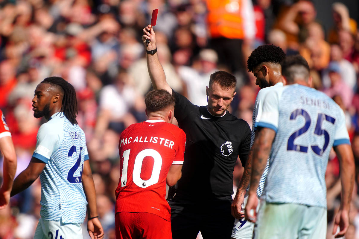 Referee Thomas Bramall pictured issuing a red card to Liverpool midfielder Alexis Mac Allister during a Premier League game against Bournemouth in August 2023