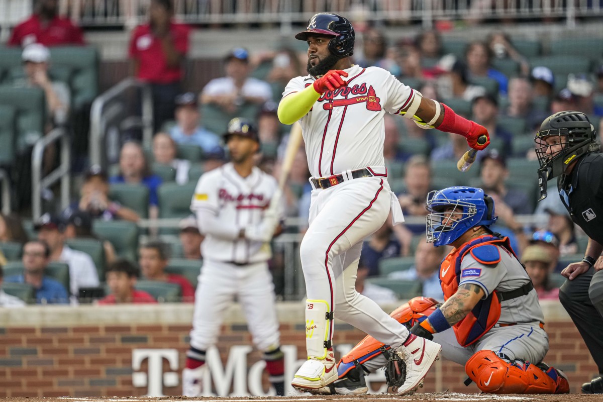 Aug 22, 2023; Cumberland, Georgia, USA; Atlanta Braves designated hitter Marcell Ozuna (20) follows through after hitting a single against the New York Mets during the second inning at Truist Park.