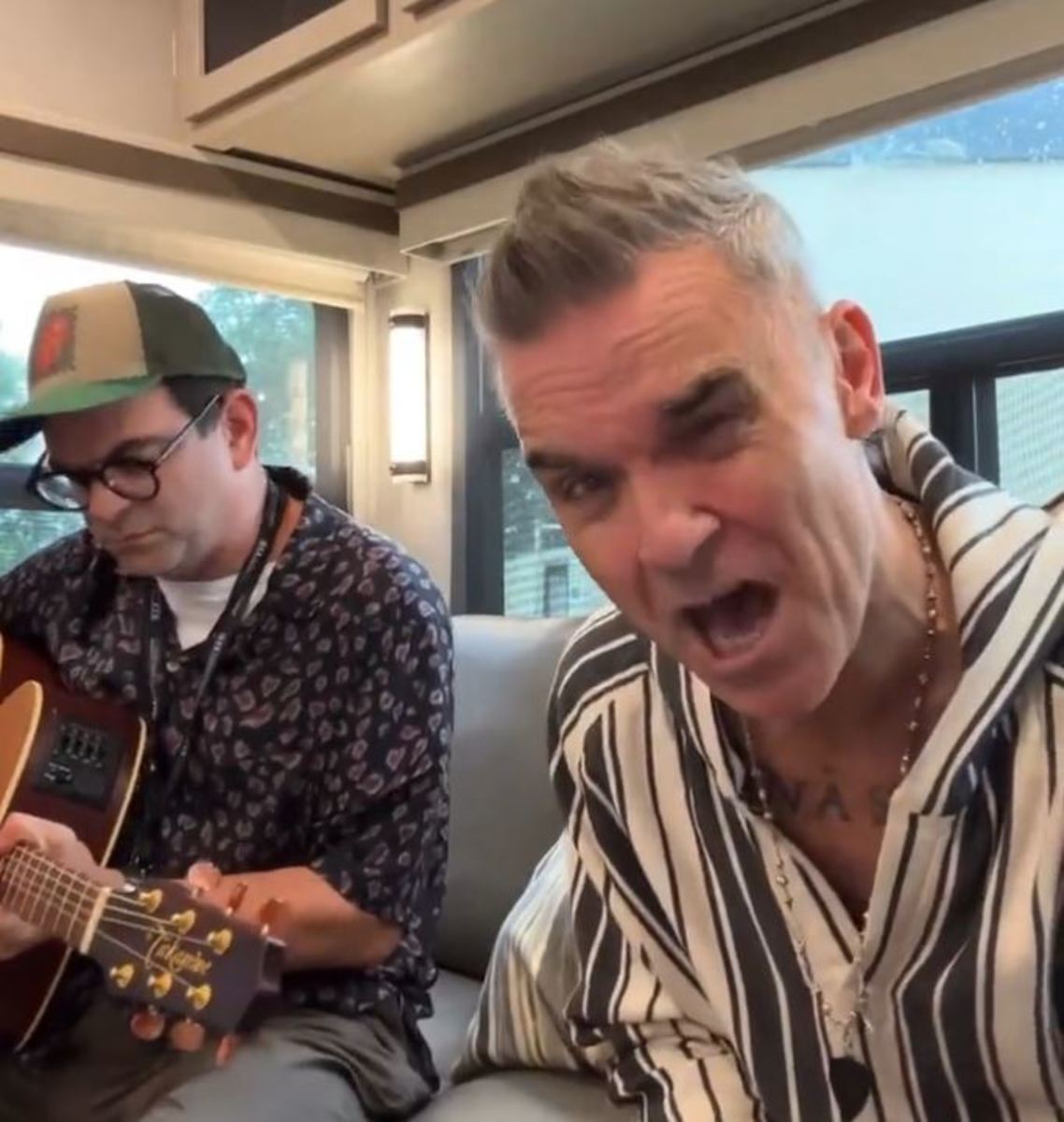 Robbie Williams pictured (right) singing 'I'm Loving Big Ange Instead' - a song created by Spurs fan James Black