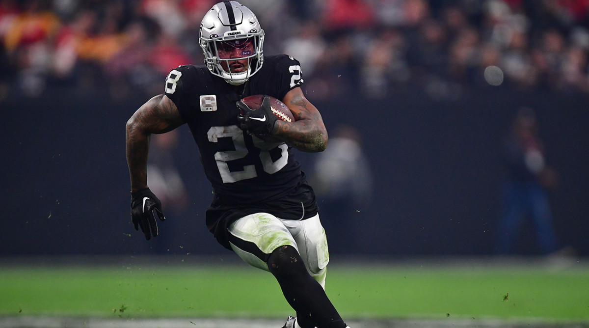 Raiders running back Josh Jacobs (28) runs the ball against the Chiefs during the second half at Allegiant Stadium.