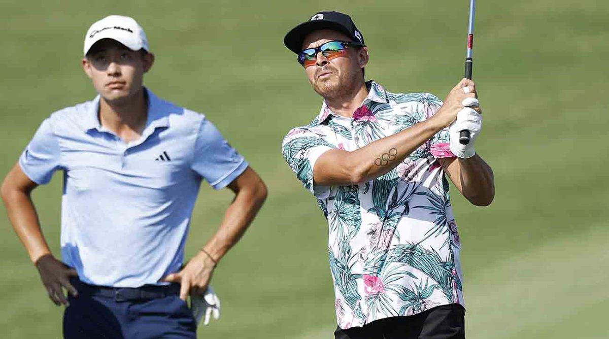 Rickie Fowler plays a shot as Collin Morikawa looks on during a practice round prior to the 2023 Tour Championship.