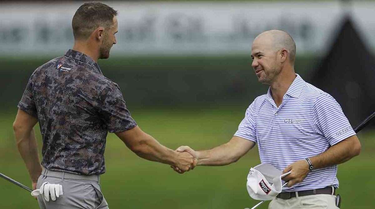 Wyndham Clark and Brian Harman shake hands after completing their rounds at the 2023 FedEx St. Jude Championship.