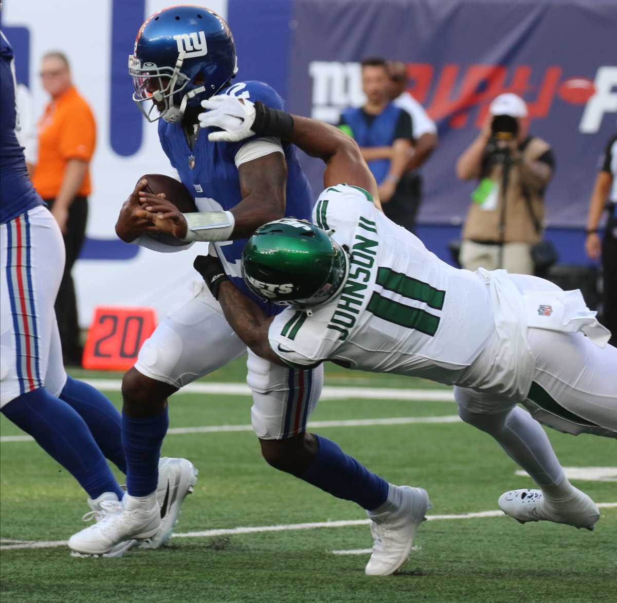 Jets' DE Jermaine Johnson (11) tackles Giants' QB Tyrod Taylor (2)