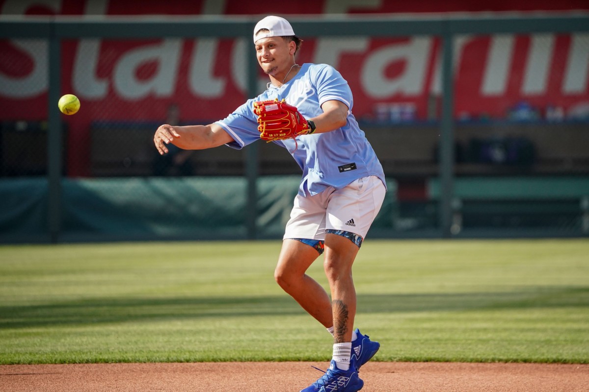 Chiefs quarterback Patrick Mahomes throws a baseball while working out with the Kansas City Royals.