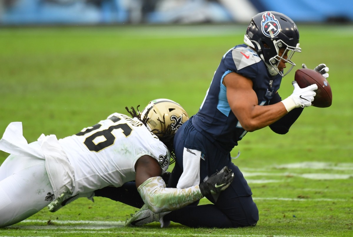 Dec 22, 2019; Tennessee Titans running back Khari Blasingame (41) is unable to hold on to a pass as he is tackled by New Orleans Saints LB Demario Davis (56). Mandatory Credit: Christopher Hanewinckel-USA TODAY Sports