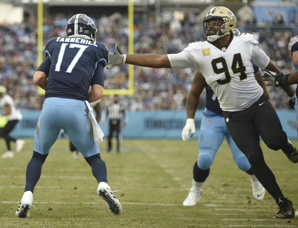 Nov 14, 2021; Tennessee Titans quarterback Ryan Tannehill (17) is pressured by New Orleans Saints defensive end Cameron Jordan (94). Mandatory Credit: Steve Roberts-USA TODAY