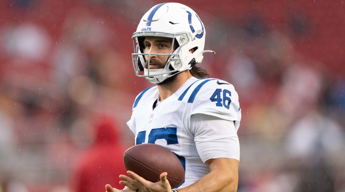 Colts long snapper Luke Rhodes holds a football in his left hand.