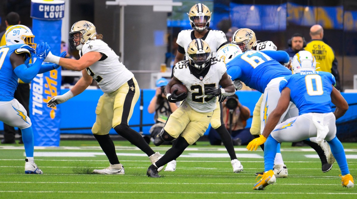 Aug 20, 2023; New Orleans Saints running back Kendre Miller (25) runs through a lane against the Los Angeles Chargers. Mandatory Credit: Robert Hanashiro-USA TODAY Sports