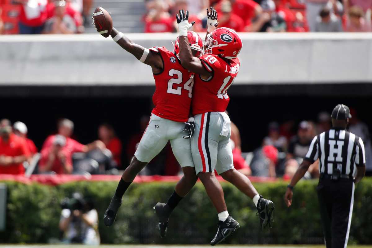 Georgia defensive back Malaki Starks (24) celebrates with Georgia linebacker Jamon Dumas-Johnson (10) after making an interception during the first half of a NCAA college football game against Ball State in Athens, Ga., on Saturday, Sept. 9, 2023.