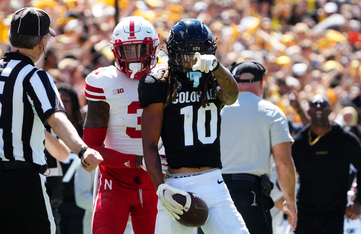 Colorado Buffaloes wide receiver Xavier Weaver (10) reacts to his first down reception catch next to Nebraska Cornhuskers linebacker Nick Henrich (3) during the third quarter at Folsom Field