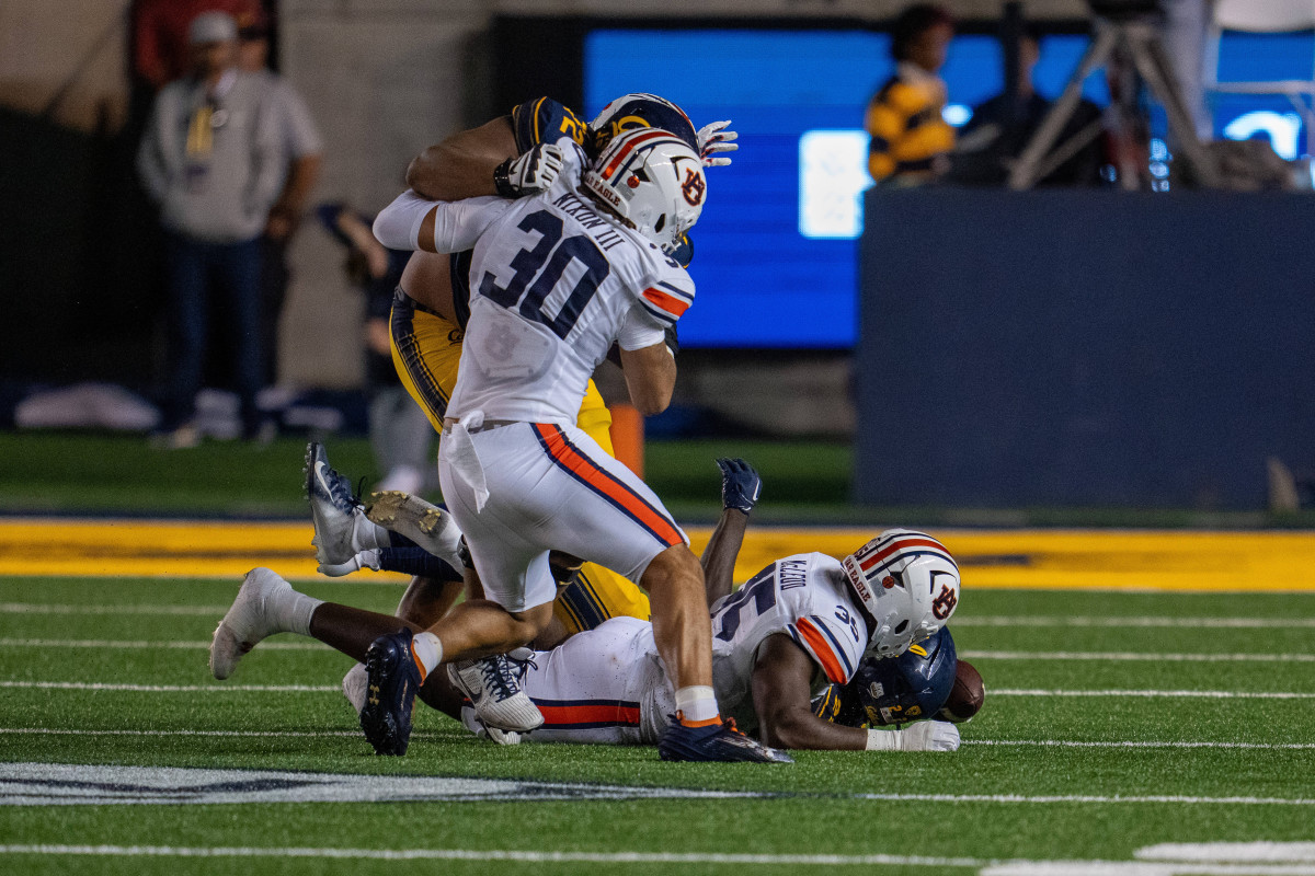 Sep 9, 2023; Berkeley, California, USA; California Golden Bears running back Isaiah Ifanse (22) fumbles the football recovered by Auburn Tigers linebacker Jalen McLeod (35) during the second quarter at California Memorial Stadium. Mandatory Credit: Neville E. Guard-USA TODAY Sports  