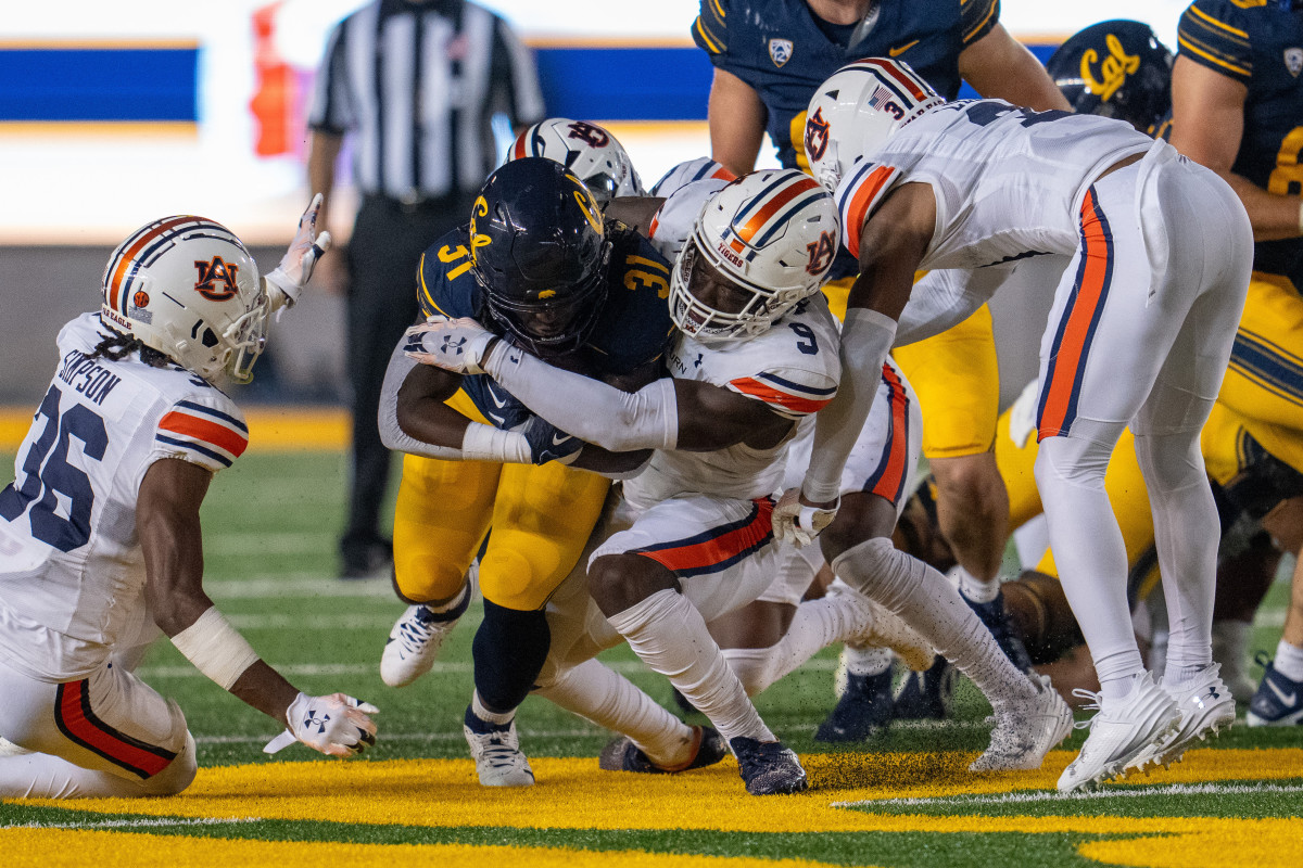 Sep 9, 2023; Berkeley, California, USA; California Golden Bears running back Ashton Stredick (31) rushes for a first down against Auburn Tigers linebacker Eugene Asante (9) during the third quarter at California Memorial Stadium. Mandatory Credit: Neville E. Guard-USA TODAY Sports  