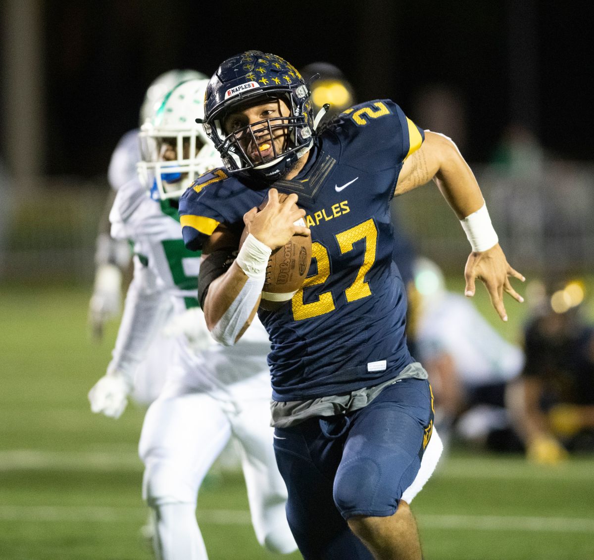 Chez Mellusi, of Naples, runs for a touchdown in his first game back from injury during the Class 6A regional semifinal playoff game against Fort Myers at Naples High on Nov. 16. Ndn 1116 Naples Football 1977134002