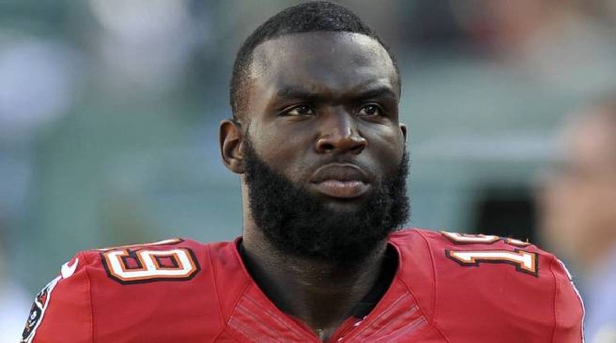 Former Buccaneers wide receiver Mike Williams looks on without a helmet during a game.