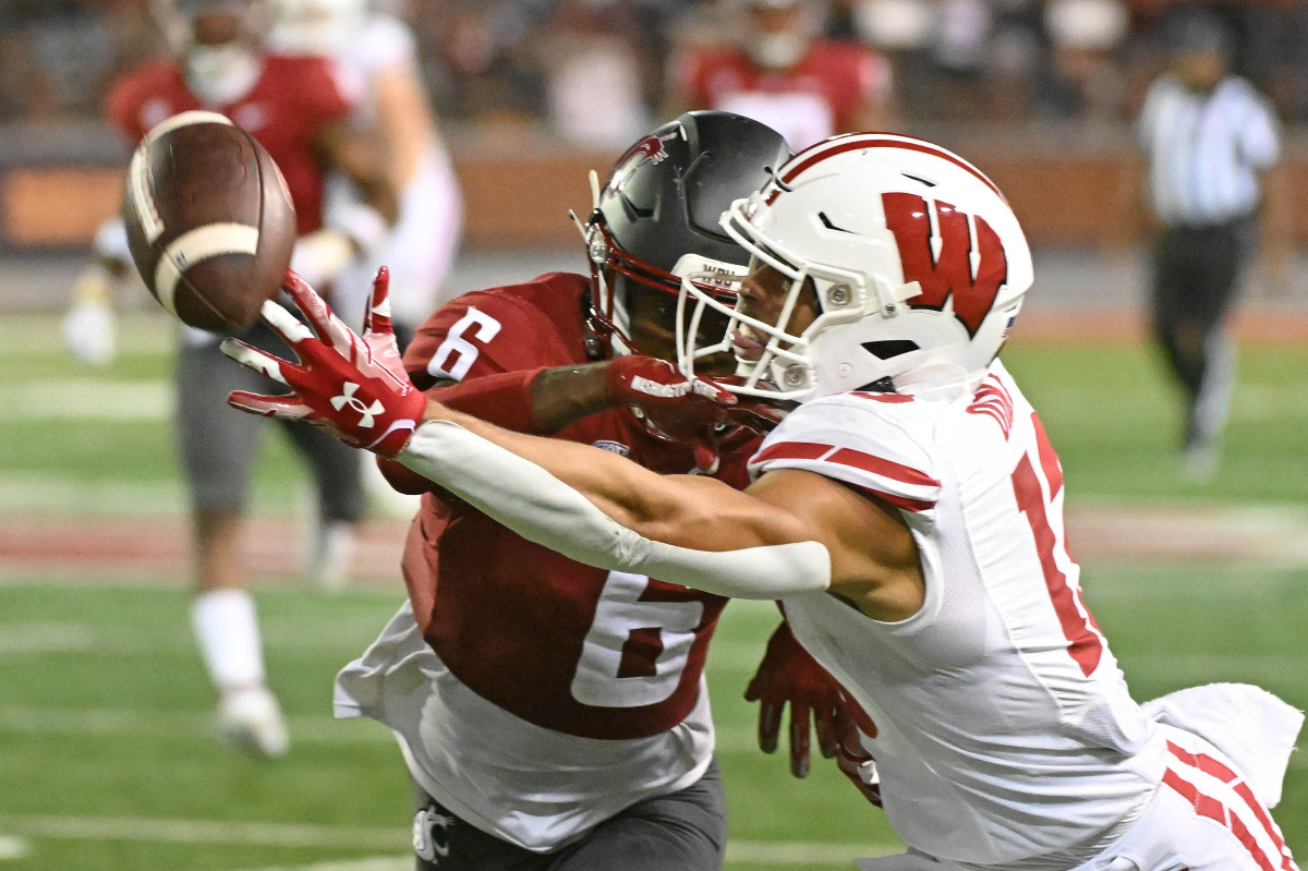 Sep 9, 2023; Pullman, Washington, USA; Wisconsin Badgers wide receiver Chimere Dike (13) has the ball deflected by Washington State Cougars defensive back Chau Smith-Wade (6) in the second half at Gesa Field at Martin Stadium. Washington State won 31-22. Mandatory Credit: James Snook-USA TODAY Sports