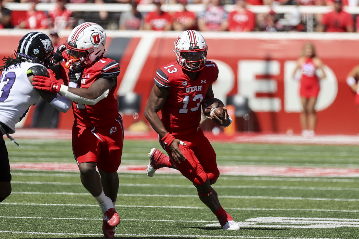 Sep 16, 2023; Salt Lake City, Utah, USA; Utah Utes quarterback Nate Johnson (13) runs the ball against the Weber State Wildcats in the second half at Rice-Eccles Stadium. Mandatory Credit: Rob Gray-USA TODAY Sports