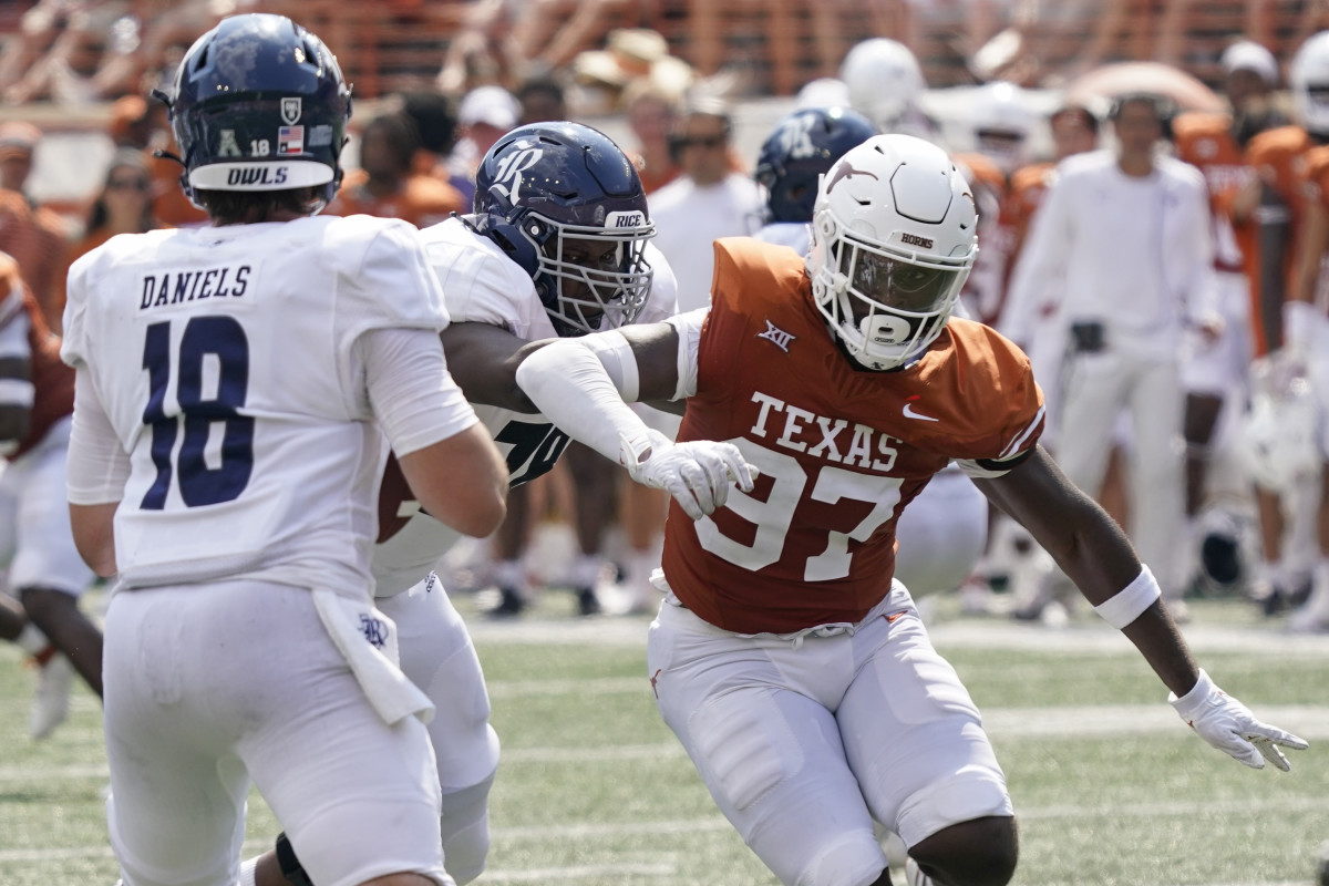 Kristopher Ross rushes Rice Owls quarterback J.T. Daniels during a game on Saturday, Sept. 2.